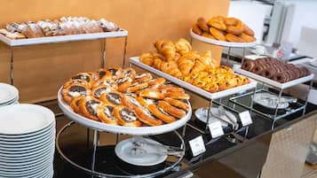 A buffet with various pastries and desserts.