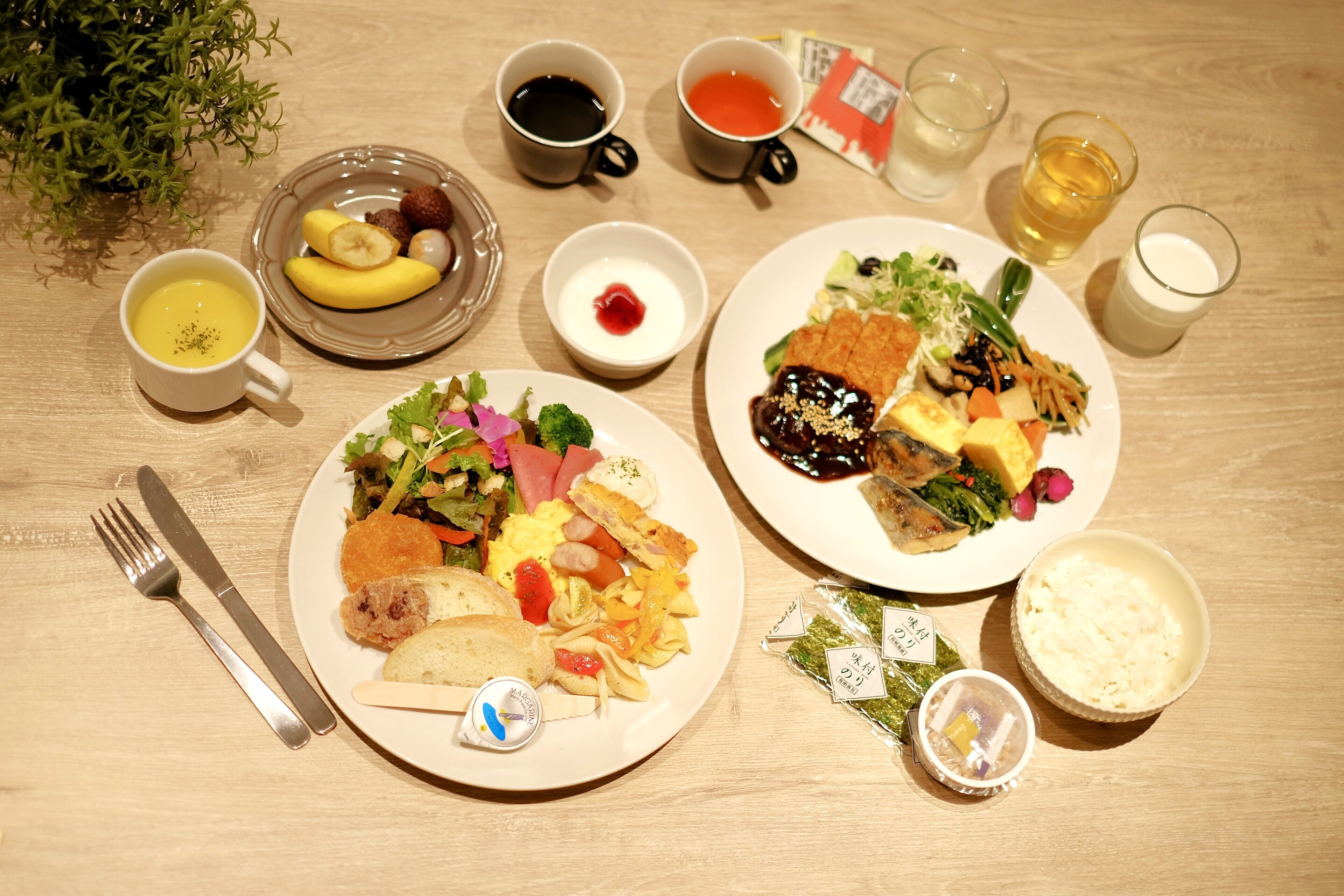 A table with two plates of food, a cup of coffee, and a glass of water.