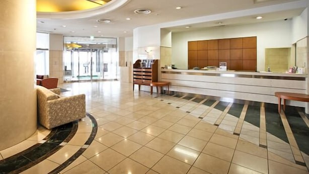 A modern lobby with a reception desk, seating area, and a glass entrance. - Hotel Tetora Otsu Kyoto (Otsu)