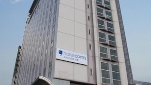 A modern hotel building with a prominent 'hotel.com' sign. - Hotel Tetora Otsu Kyoto (Otsu)