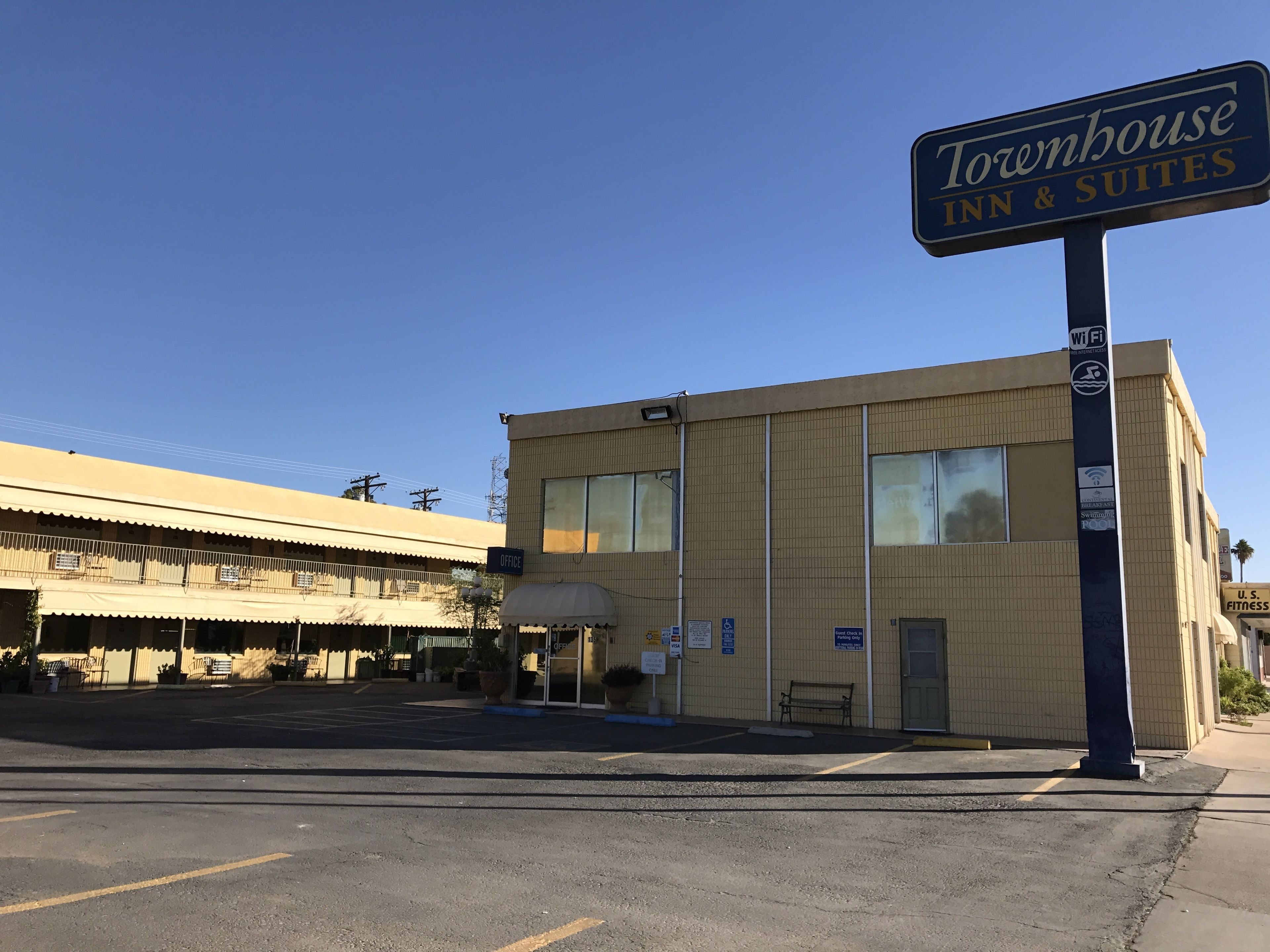 A Townhouse Inn & Suites building with a sign indicating Wi-Fi availability.