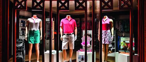 A clothing store window display with mannequins in sportswear.