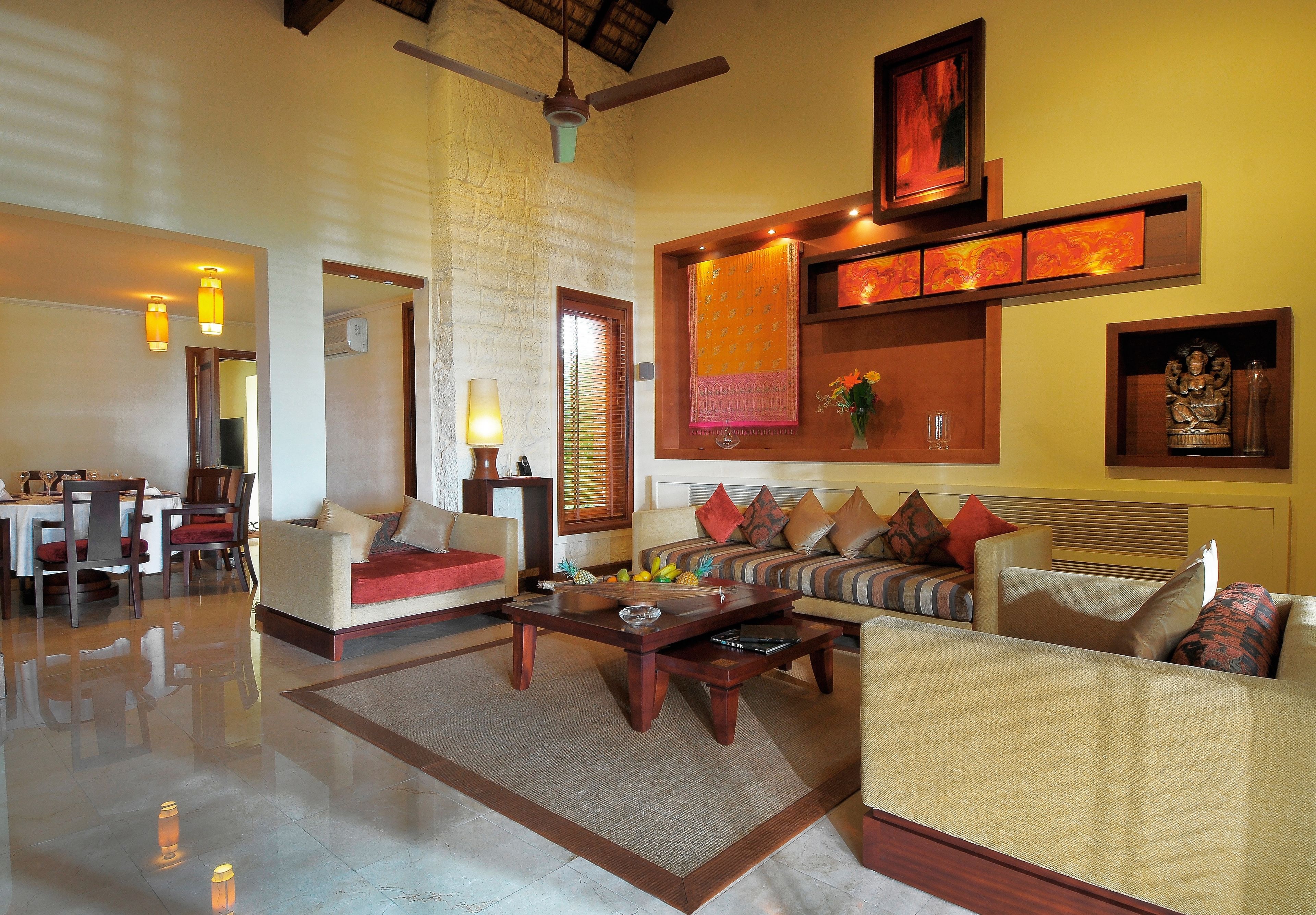 A spacious living area with a dining table, sofas, and a coffee table.
