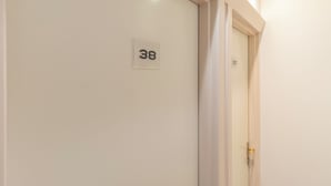 A hallway with doors numbered 37 and 38. - Hotel Riviera (Paris)