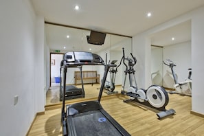 A gym with a treadmill, elliptical, and stationary bikes. - Hotel Santana (St. Paul's Bay)