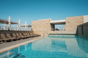 Seasonal outdoor pool, open 8:00 AM to 7:00 PM, pool umbrellas