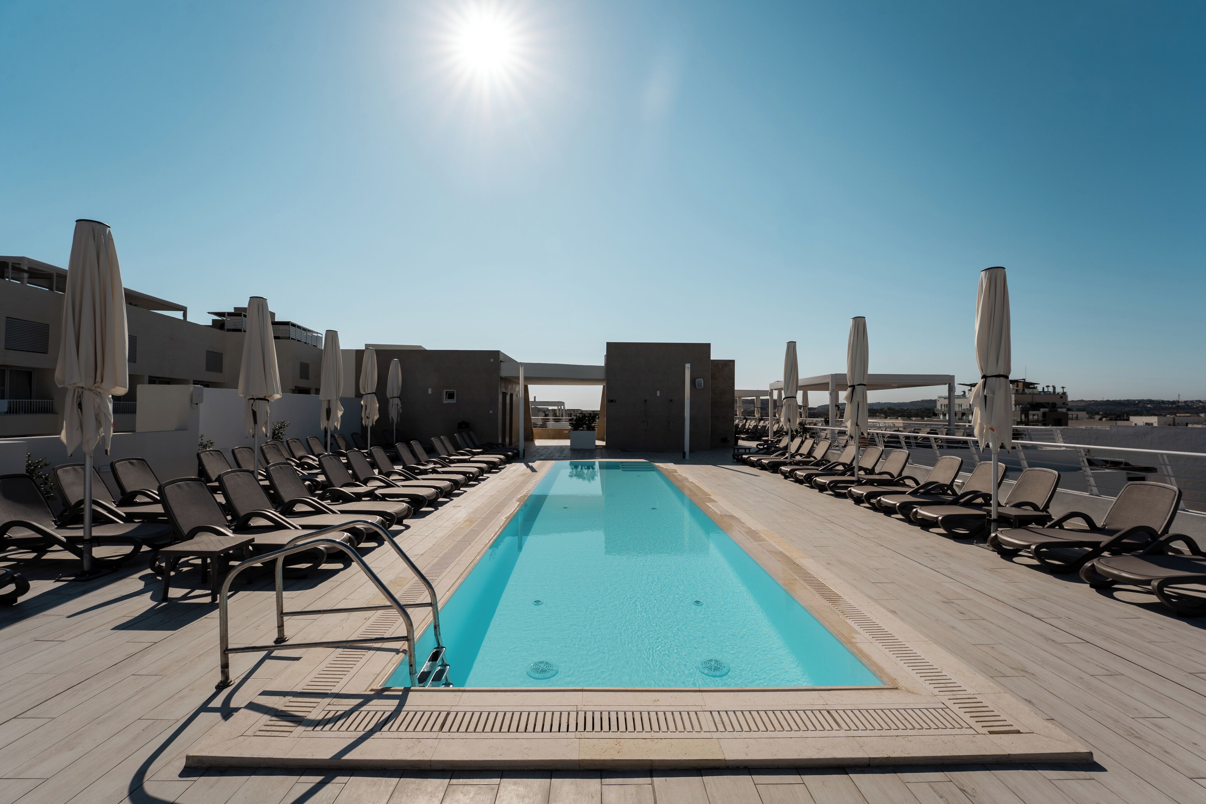 Seasonal outdoor pool, open 8:00 AM to 7:00 PM, pool umbrellas