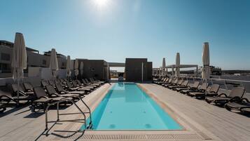 Seasonal outdoor pool, open 8:00 AM to 7:00 PM, pool umbrellas