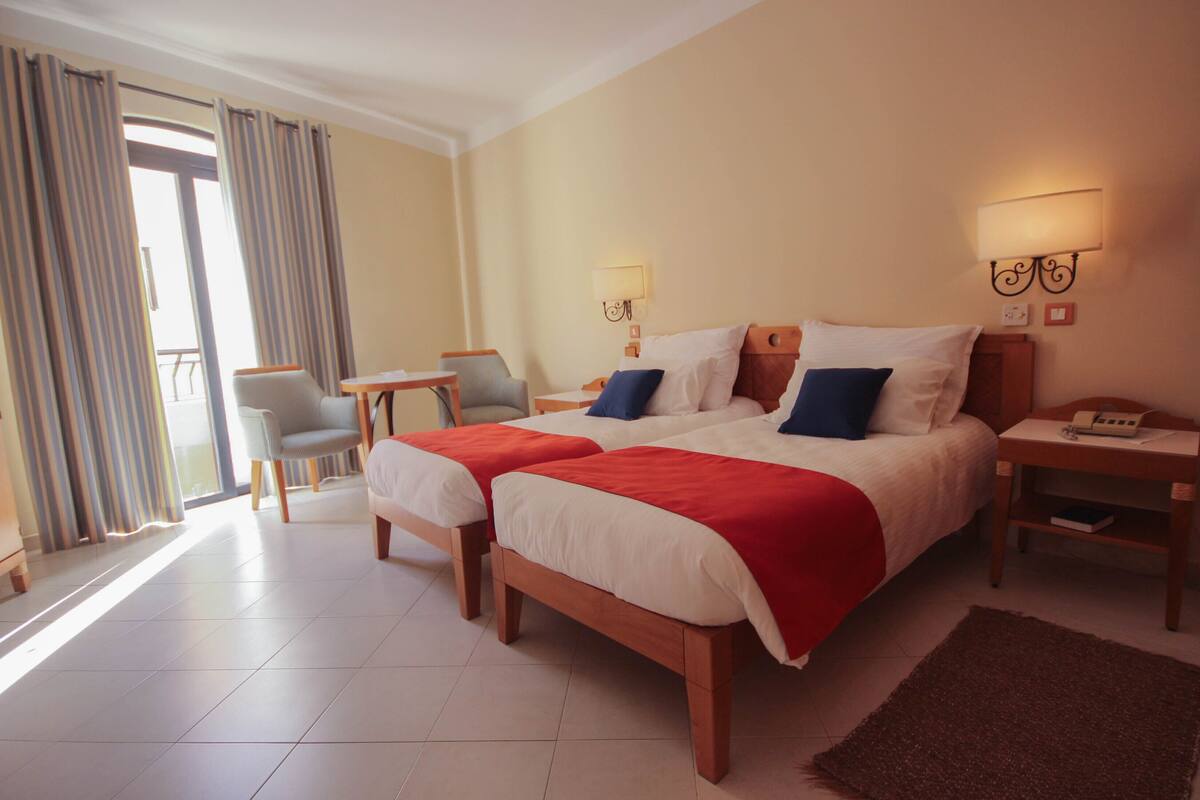 standard room, sea view | minibar, in-room safe, desk, blackout curtains