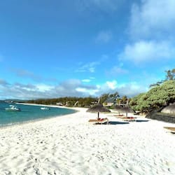 On the beach, white sand, sun-loungers, beach umbrellas