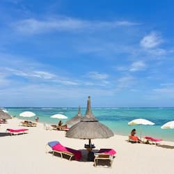 On the beach, white sand, sun-loungers, beach umbrellas