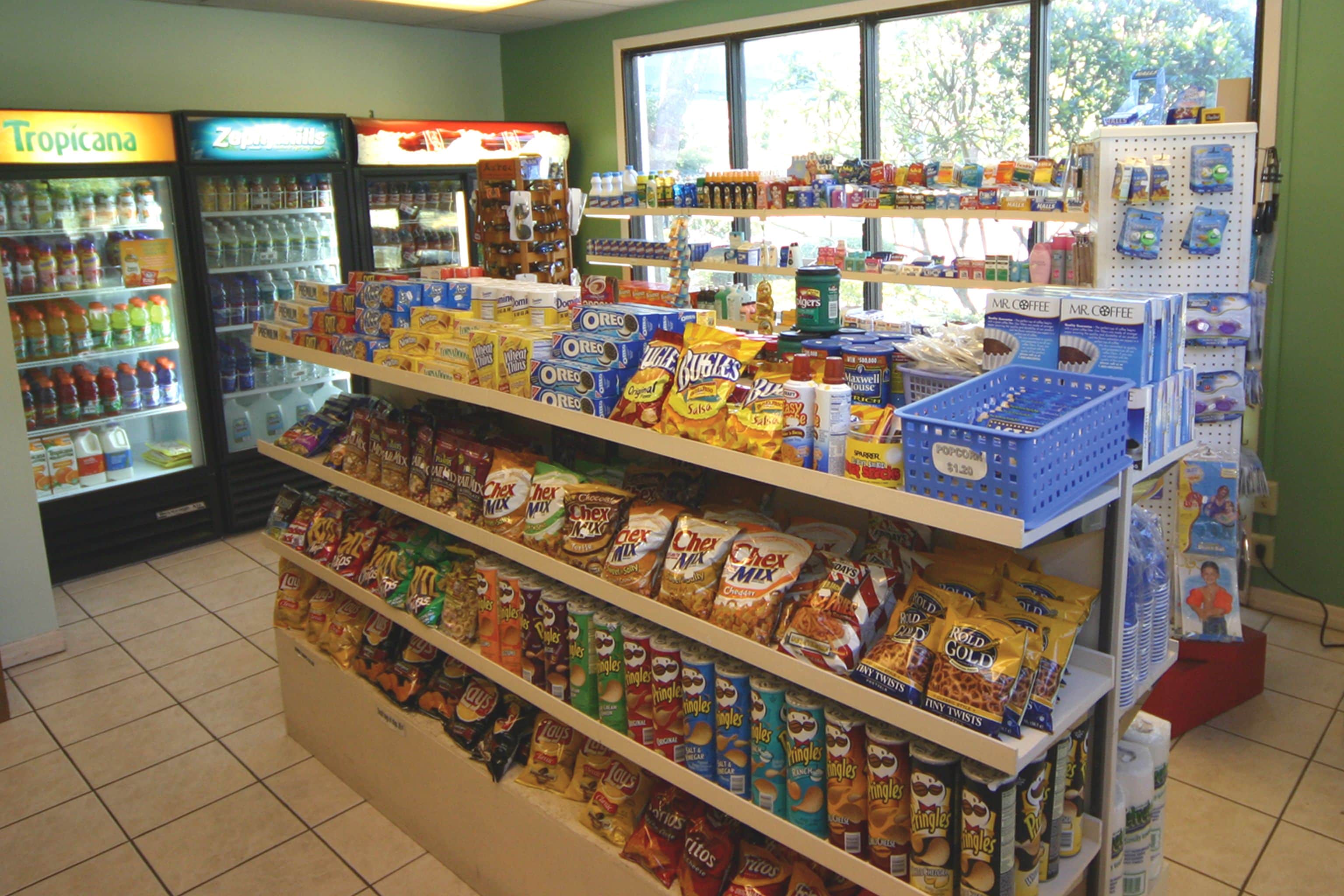 A grocery store with shelves stocked with snacks and beverages.