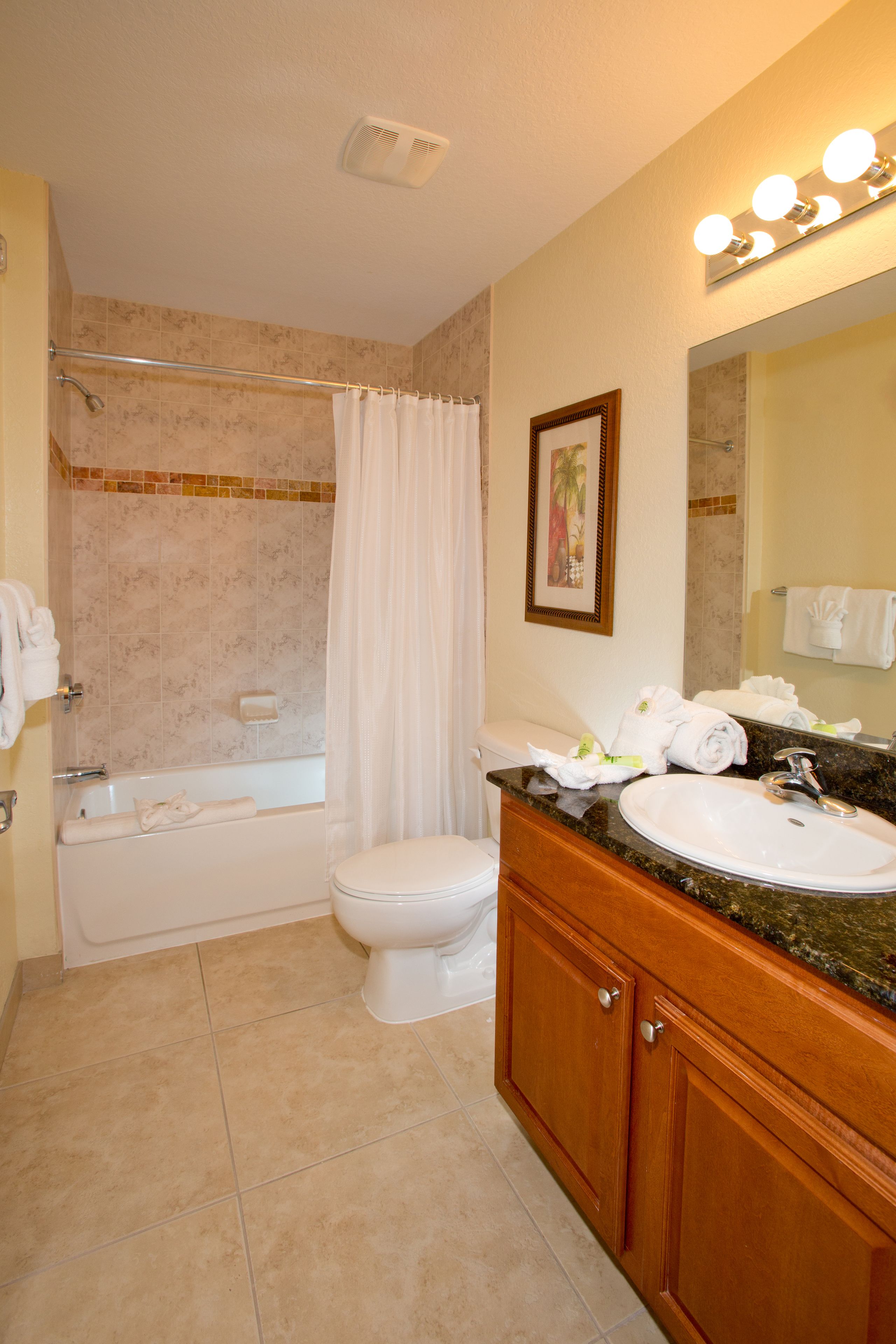 A bathroom with a bathtub, toilet, and sink.