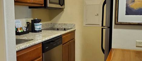 Fridge, microwave, coffee/tea maker, cookware/dishes/utensils