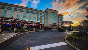Welcome to The Mainland, where a covered walkway leads to the hotel's entrance, flanked by a series of windows.