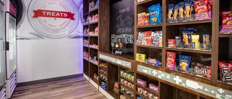 A snack aisle with various packaged treats and a sign that reads "TREATS".