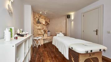 Relax in this serene space with a massage table and toiletries at the ready.