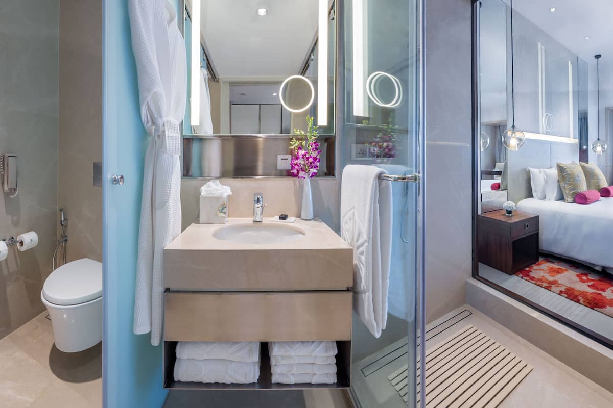 apollo sea view king bed | bathroom | shower, designer toiletries, hair dryer, bathrobes