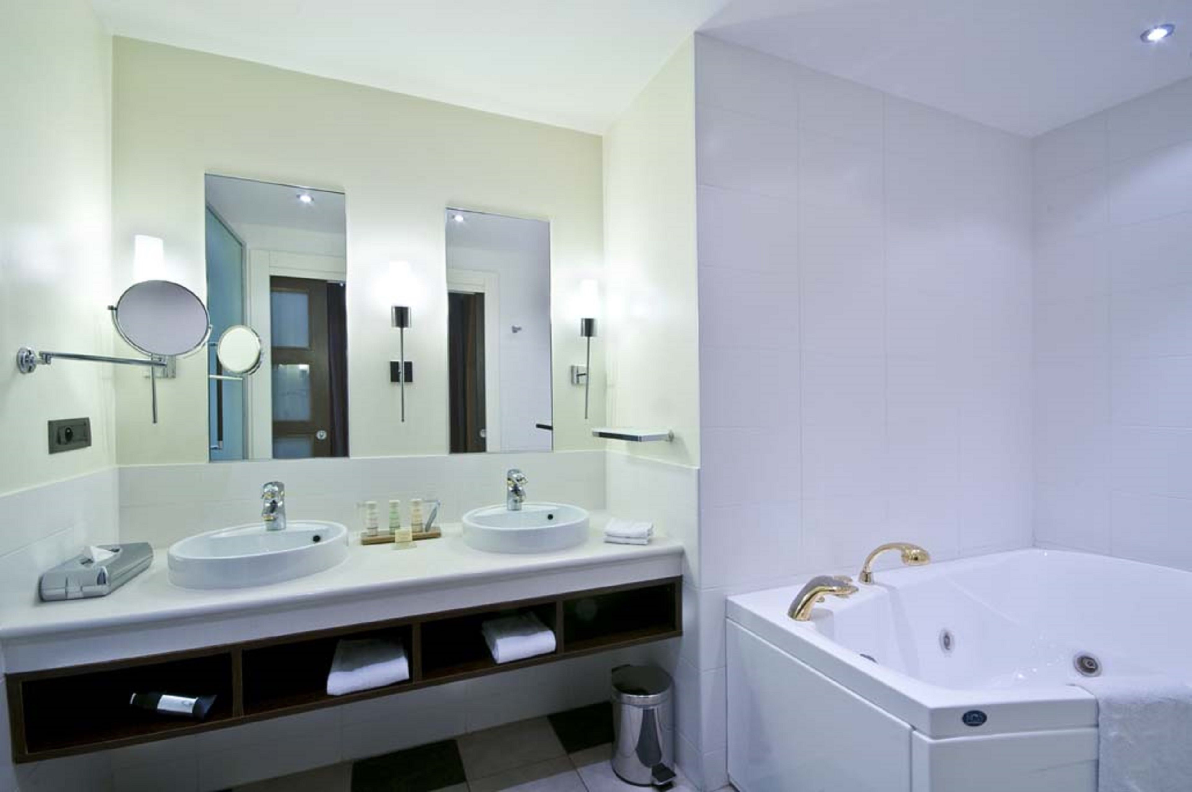 Designer toiletries, hair dryer, slippers, towels