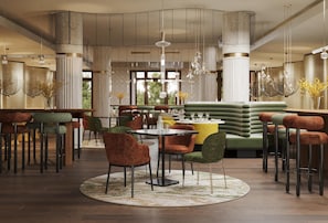 Un interior modern amb sostres alts, una taula rodona central i tamborets de bar.