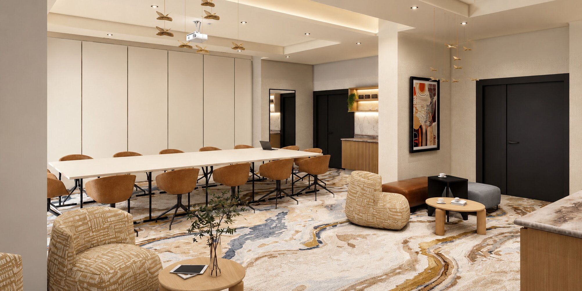 A modern hotel lobby with a long conference table, comfortable seating, a decorative rug, and a large artwork on the wall.