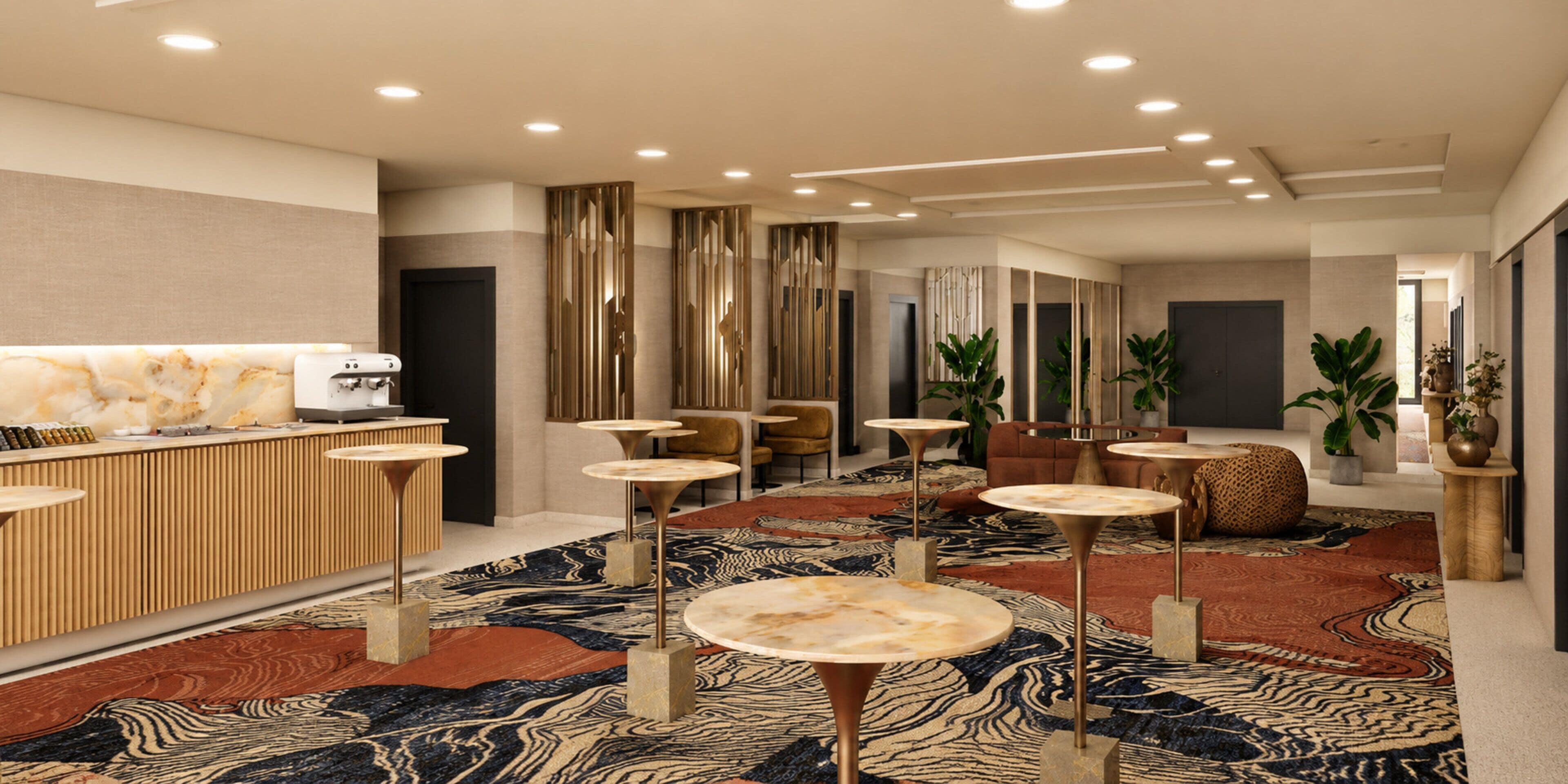 Eine moderne Lobby mit Empfangsschalter, Sitzbereichen und einem gemusterten Teppich.