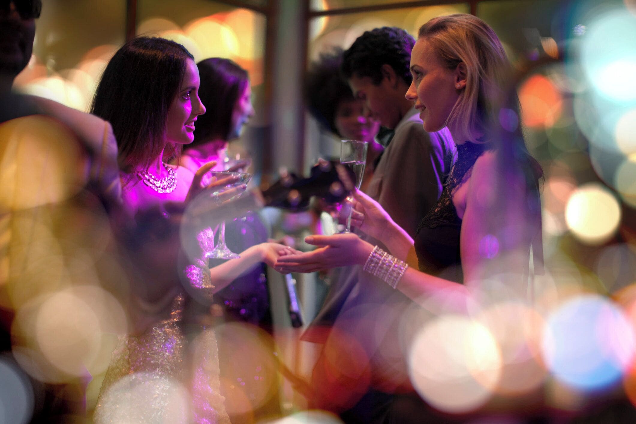 A social event with people holding drinks, possibly a celebration or gathering.
