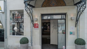 The entrance to a hotel with a sign indicating it is a restaurant.