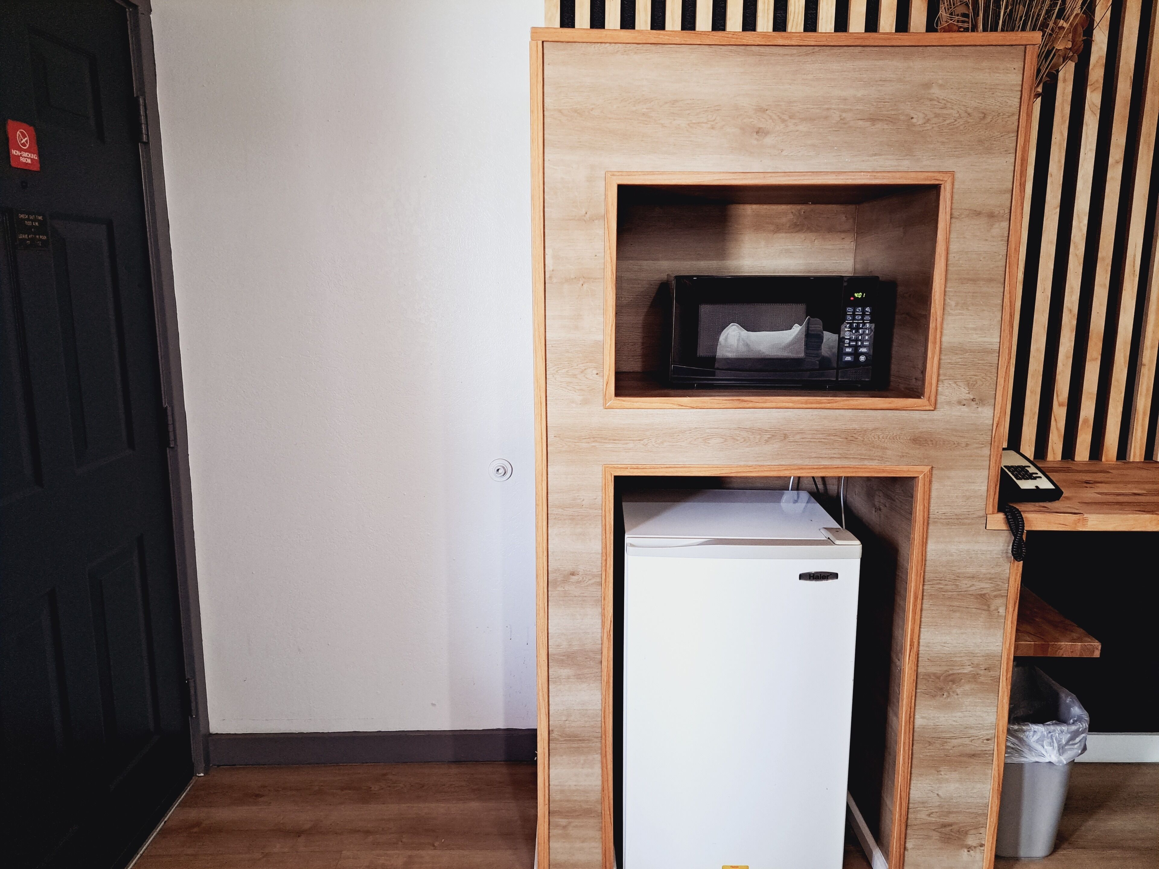 A compact kitchenette with a microwave and a mini-fridge.