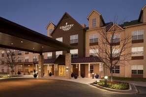 A Country Inn & Suites building with a prominent sign, multiple entry points, and a well-lit entrance area. - Country Inn & Suites by Radisson, Aiken South (Aiken)