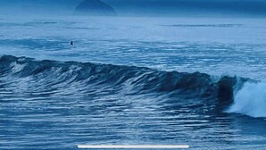 A coastal scene with waves and a distant island. - Morro Bay Beach Inn (Morro Bay)