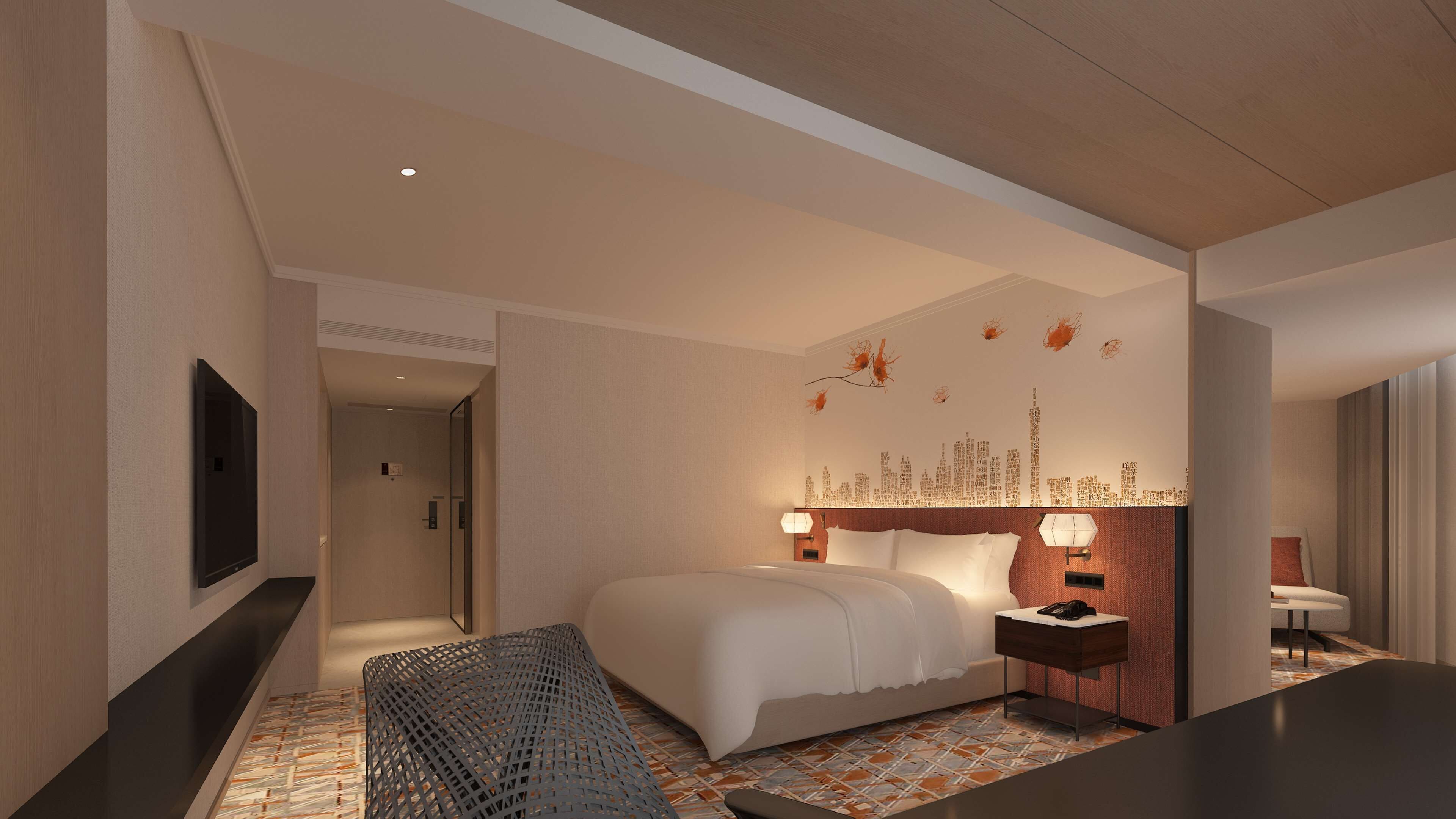 A modern hotel room with a large bed, a desk, a TV, and a cityscape wall decoration.