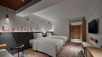 A modern hotel room with a bed, bedside tables, a seating area, and a TV.