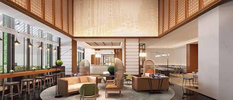 A spacious lobby with a high ceiling, modern furniture, and a central seating area.