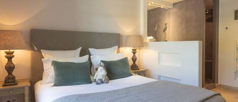 A neatly arranged bedroom with a bed, two bedside tables, and a nightstand.