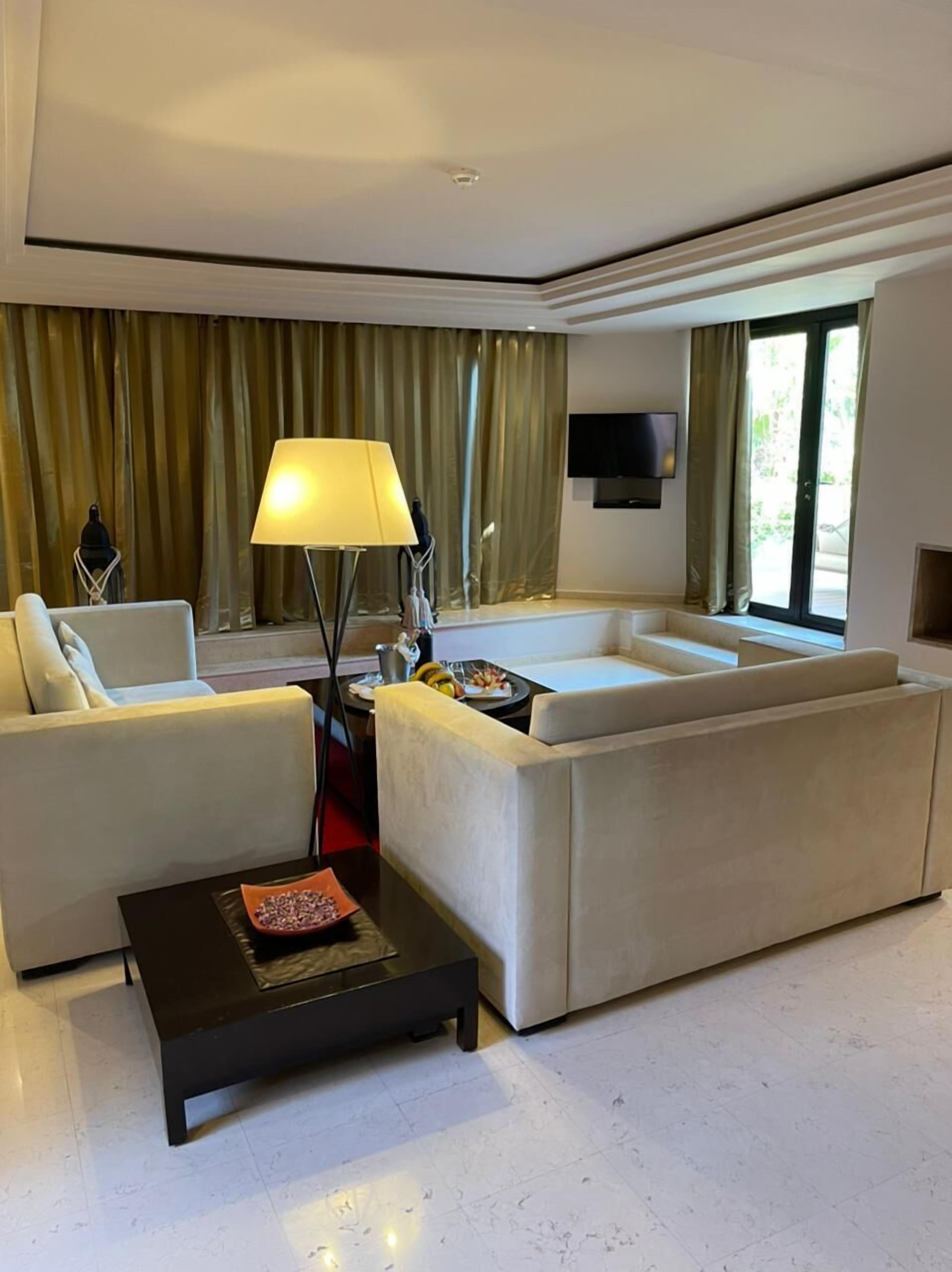 A modern living room with a sofa, a coffee table, and a TV.