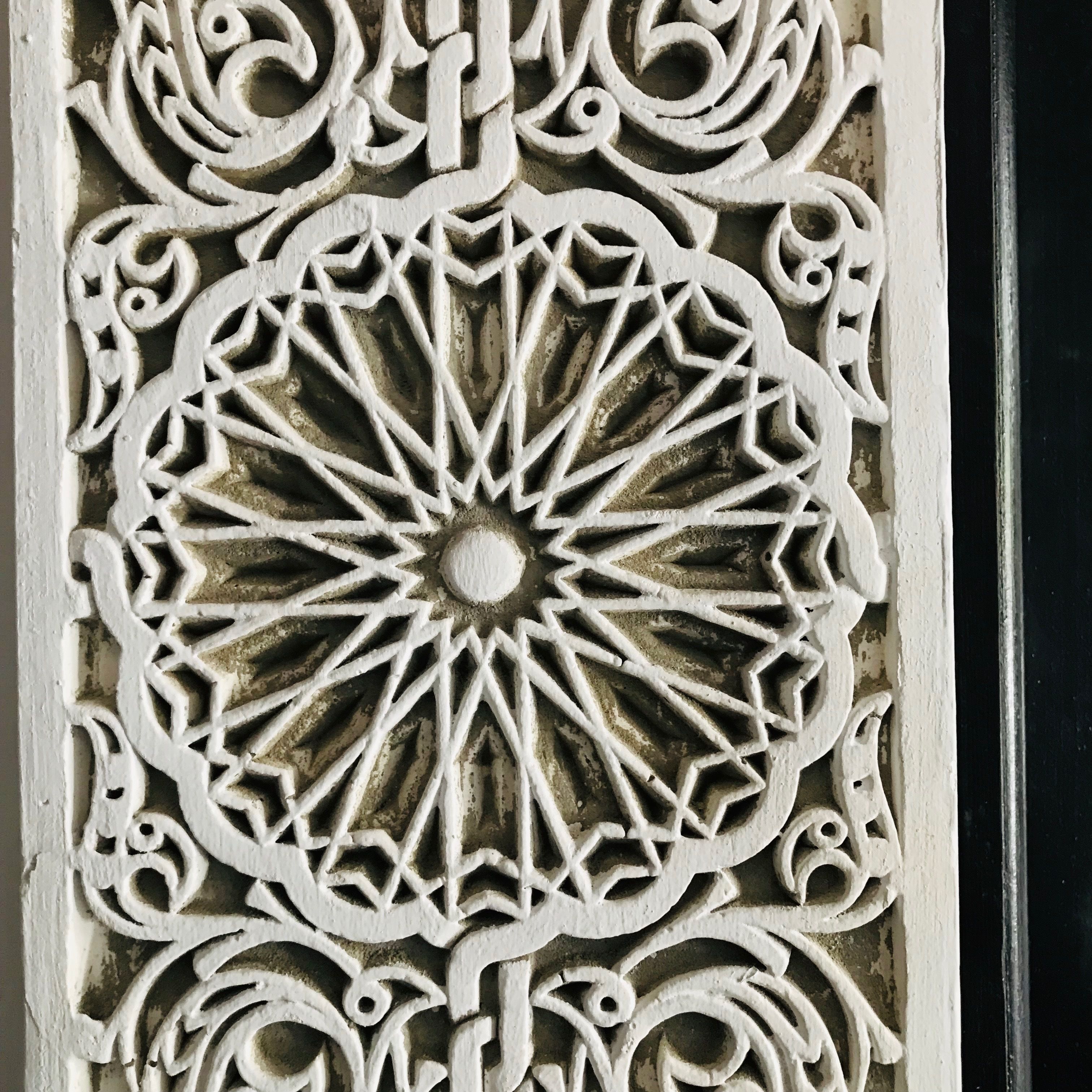 A detailed ornamental metalwork design, likely part of a building's facade or architectural feature.