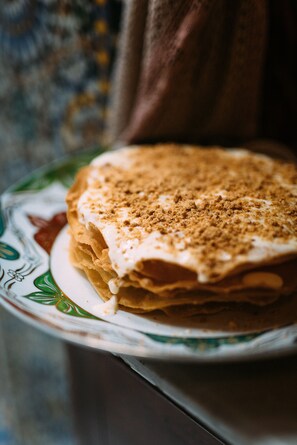 A stack of pancakes on a plate with a floral pattern.