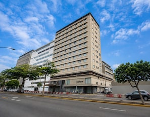 A multi-story hotel with a flat facade, large windows, and a ground-level entrance.