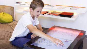 A child interacting with a digital drawing tablet.