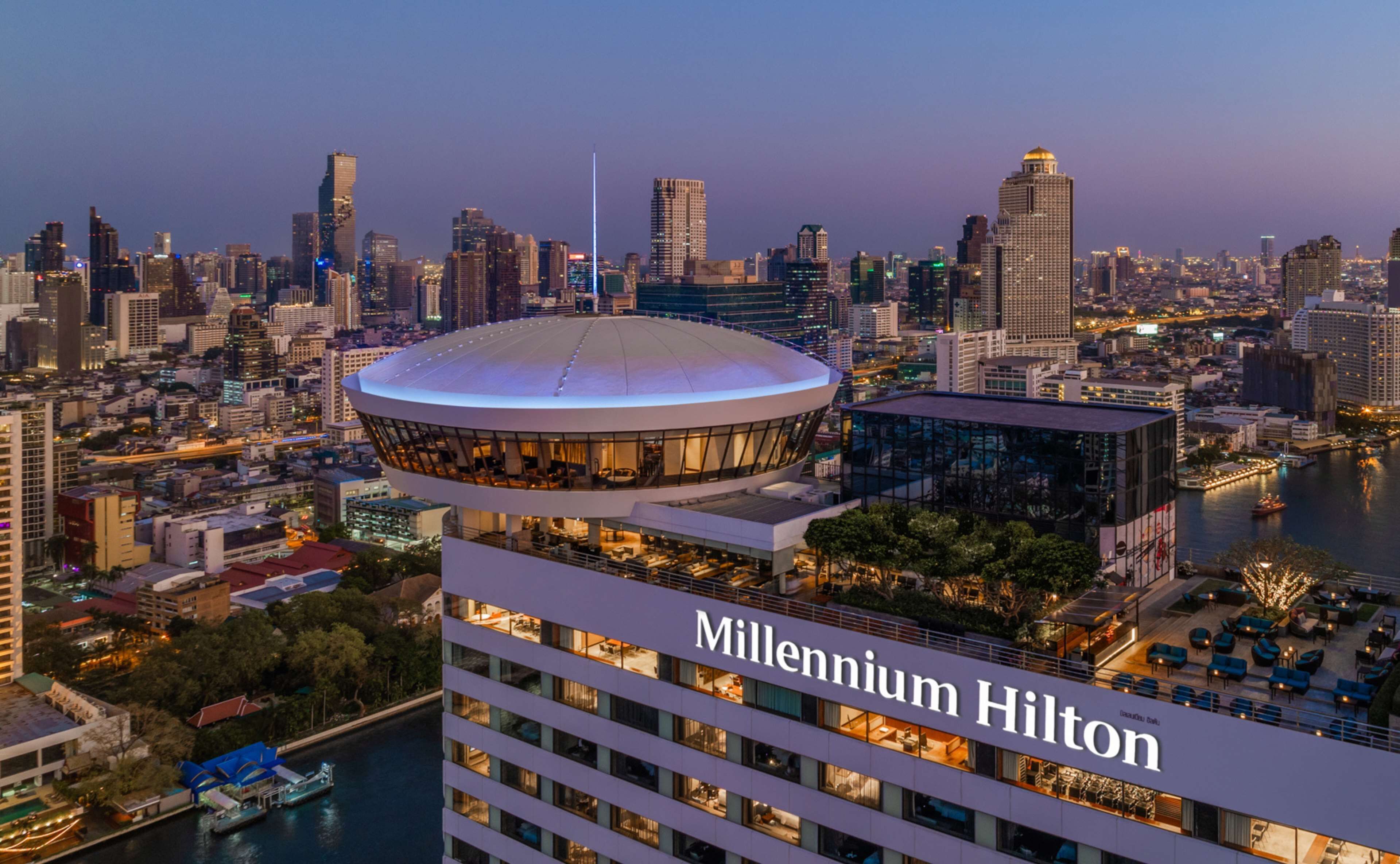 A high-rise hotel with a prominent dome structure and a modern glass facade.