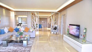 A spacious living area with a sofa set, a coffee table, and a flat-screen TV on a stand. - Zaki Hotel  (Meknes)