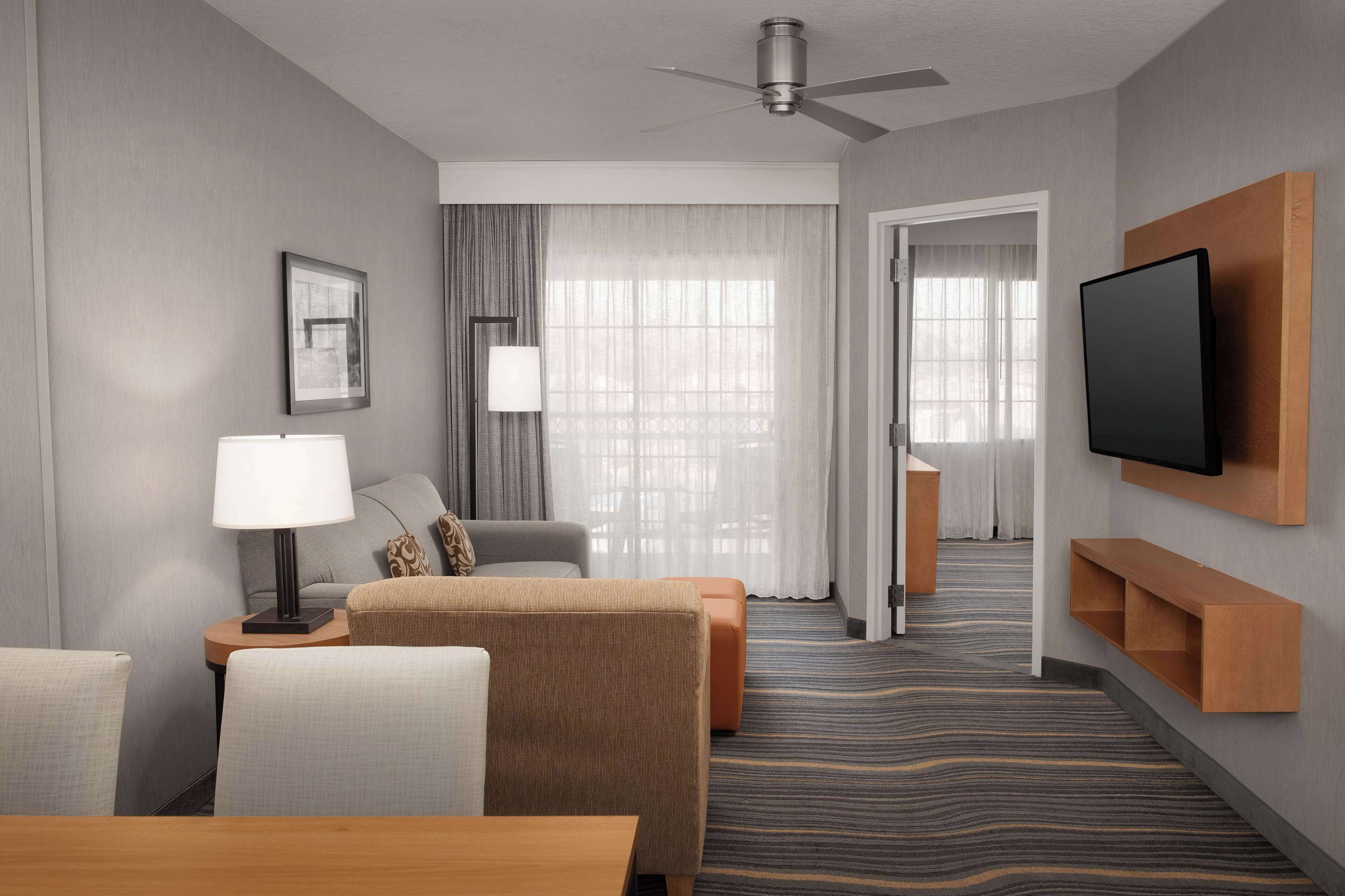 suite, 1 king bed, non smoking, corner | living area | 27-inch tv with cable channels, video game console