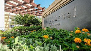 A hotel entrance with a sign reading "ENVIAHotel Wellness & Golf".
