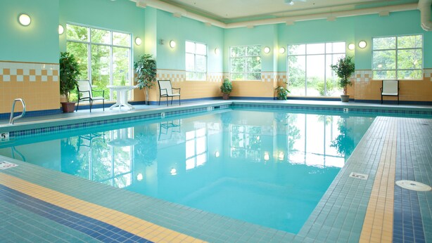 An indoor swimming pool with clear blue water, tiled walls, and windows. - Best Western Plus Chemainus Inn (Chemainus)