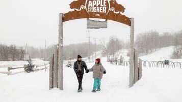 A wooden archway with the sign "Apple Crusher" and "Columbia" written on it.