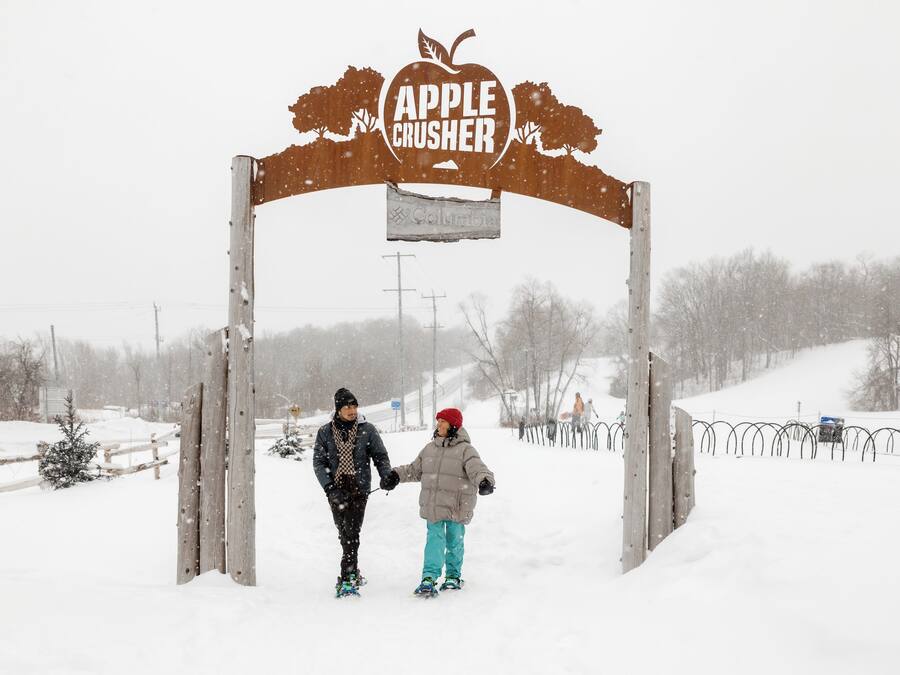 A wooden archway with the sign "Apple Crusher" and "Columbia" written on it.