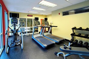 A gym with treadmills, a stationary bike, and dumbbells. - Courtyard by Marriott St George (St. George)