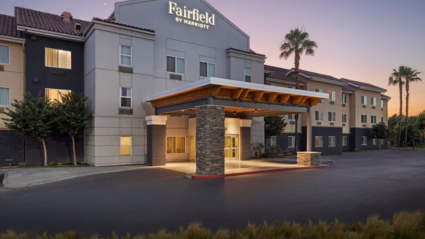 A Fairfield by Marriott hotel with a modern facade, a covered entrance, and a landscaped driveway.