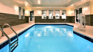 A swimming pool with a clear blue water, surrounded by walls with a wooden panel design, and equipped with a ladder and a water filtration system. - Fairfield by Marriott Inn & Suites Richmond Innsbrook (Richmond)